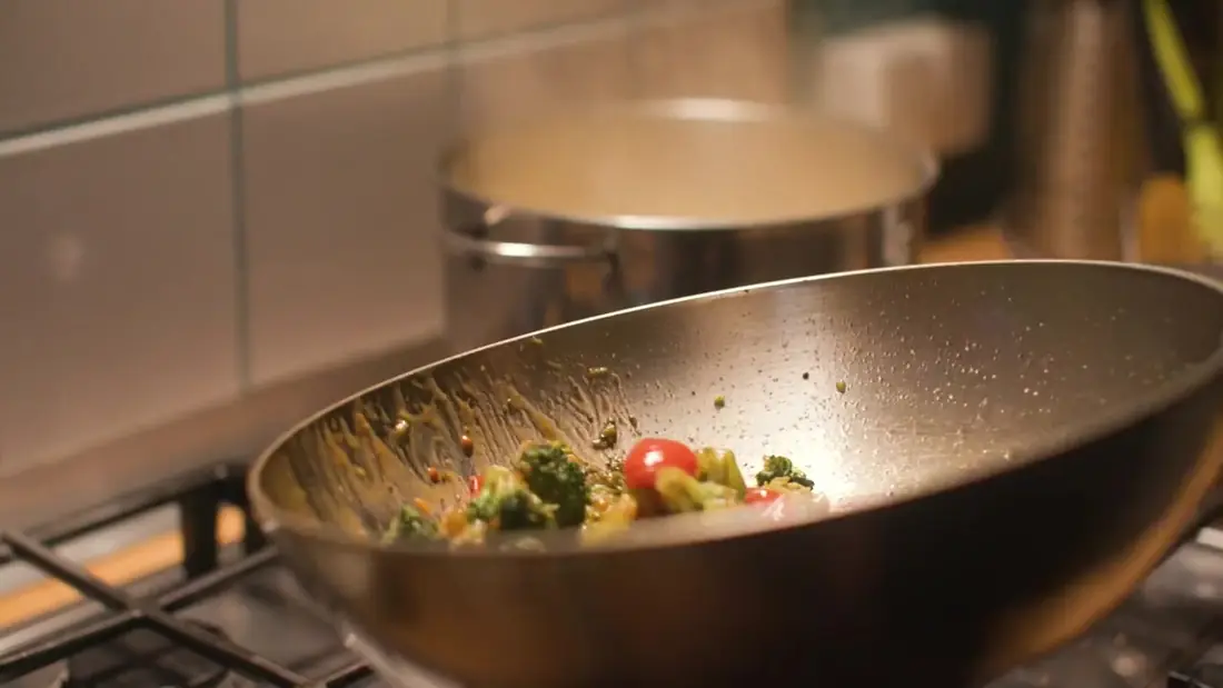 A pan of vegetables on the stove