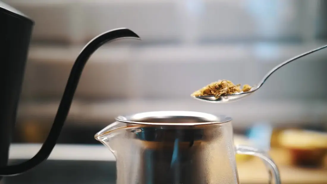 Herbal tea poured from a kettle